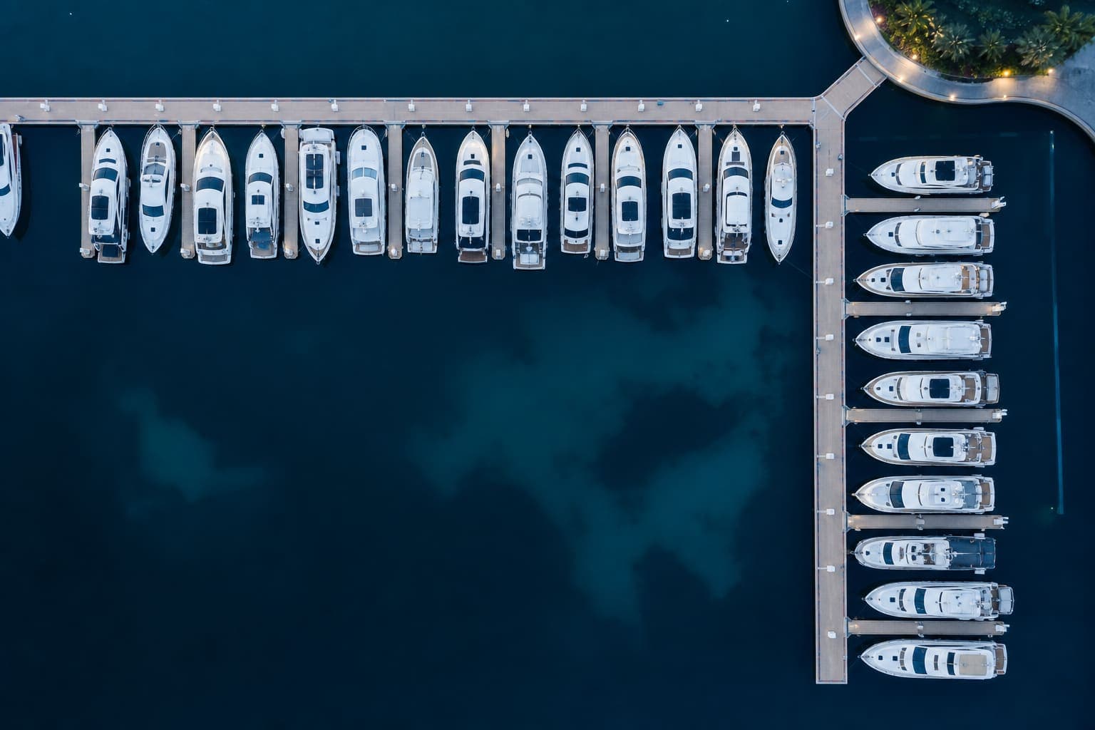 Aerial view of a marina lined with modern yachts